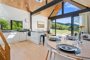 a kitchen and dining room with a table and chairs at The Cabin - Wellington Holiday Home in Wellington