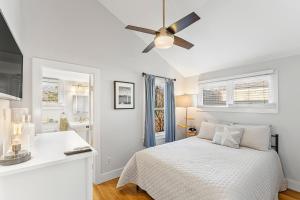 a white bedroom with a bed and a ceiling fan at Fresh Pond Chateau Renovated Bright and Cozy Home in Oak Bluffs