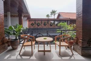 d'une terrasse avec une table et des chaises sur un balcon. dans l'établissement Pondok DD Canggu, à Canggu