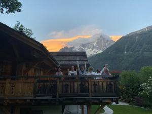 a group of people standing on a balcony of a house at Edelweiss Yoga Chalet in Chamonix