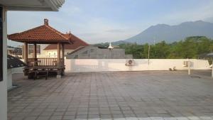 a patio with a bench and a gazebo at Villa Puncak Tidar M-20 in Kasri