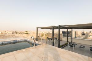 a swimming pool on the roof of a building at Stella Stays Olaya Tower 1 in Riyadh