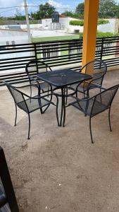 a black table and chairs sitting on a patio at Casa de la esquina in Santa María del Oro