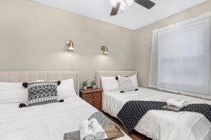 a bedroom with two beds and a window at Chic, modern retreat, kids&dog friendly, DT Matthews in Charlotte