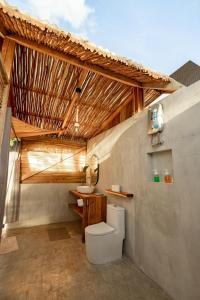 a bathroom with a toilet and a sink at Domes and Dreams Lio Glamping in El Nido