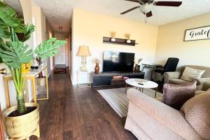 a living room with a couch and a tv at Foundation Paradise in Fayetteville