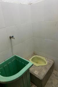 a dirty bathroom with a toilet and a tub at OYO Life 93259 Kos Kurnia in Tanjung