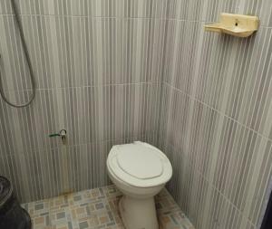 a small bathroom with a toilet and a shower at OYO Life 93265 Kos Cendana Seruni Raya in Mataram