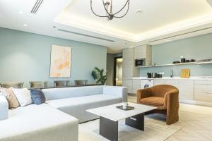 a living room with a couch and a table at Stella Stays Olaya Tower 1 in Riyadh