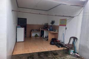 a kitchen with a refrigerator and a tile floor at SPOT ON 93553 Juan Kostel in Banyumas