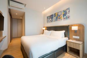a bedroom with a white bed and a tv at Zenity 3BR Condo: Luxury and Comfort in Quận 1 in Ho Chi Minh City +27 photos
