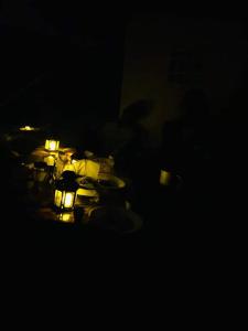 a table with lit candles in a dark room at Nuba falcon in Aswan