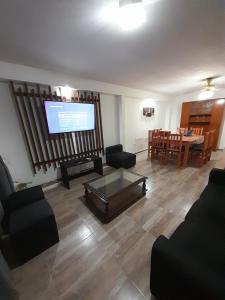a living room with a flat screen tv and furniture at Casa Blend in Las Heras