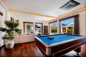 a large living room with a pool table at Villa Tramonto By Le Cielo in Canggu