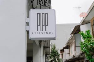 a sign for a residence on the side of a building at Pipp Residence in Bangkok