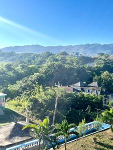a view of the mountains from a house at Andeve's quiet, private room with fully equipped shared space !home away from home in Montego Bay