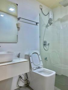 een badkamer met een toilet, een wastafel en een douche bij Resting View in Male City