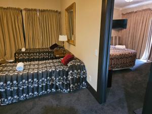 Voodi või voodid majutusasutuse Gateway Motor Inn toas