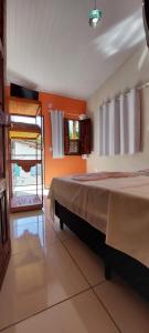 a bedroom with a large bed in a room at Mary Suítes in Lençóis