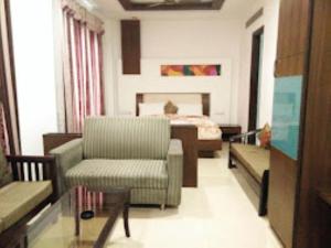 a living room with a couch and a bed at Hotel Mahal Inn,Amritsar in Amritsar