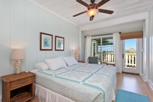 a bedroom with a bed and a ceiling fan at Hale Kainalu in Kailua