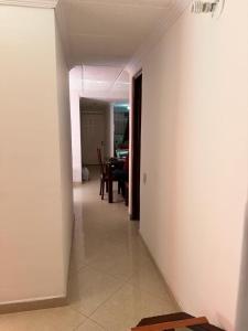 a hallway leading to a dining room with a table at Apartamento Ciudad Salitre Bogota - Amoblado in Bogotá