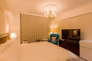 una camera d'albergo con letto e TV di Himalaya Cloud Hotel a Tokyo