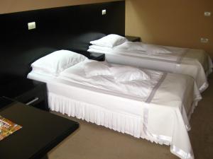 Un pat sau paturi într-o cameră la Hotel Delpack