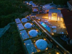 una vista aérea de un edificio con domos por la noche en Glamping Resort GLANSO NAGASAKI, en Nagasaki