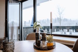 a table with candles on it in front of a window at Chalet Alpenblick I Sport I Parken I WLAN in Pfronten