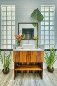 a bathroom with a sink and a mirror at Kajali Siargao in General Luna