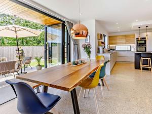 a kitchen and dining room with a wooden table and chairs at 4 Bed in Bude 83619 in Stratton