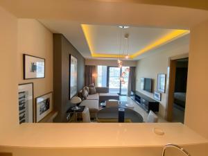 a living room with a couch and a table at AMAZNING VIEW & PARAMOUNT BRANDED TWO BEDROOM APARTMENTS BRUJ VIEW in Dubai