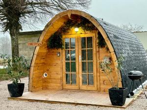 ein kleines Holzhobbit-Haus mit großer Tür in der Unterkunft Les Chalets du Parc 