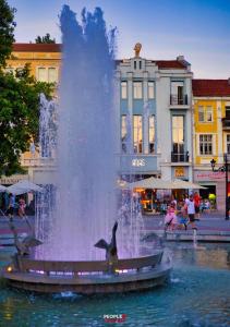 a fountain in the middle of a city with dolphins at ATLAS HOUSE Luxury Suites in Plovdiv