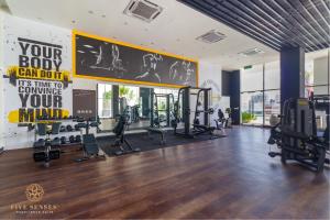 a gym with treadmills and exercise equipment on the wall at Quill Residences Kuala Lumpur, Five Senses in Kuala Lumpur