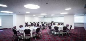 a conference room with tables and chairs in it at Metropolitan Hotel in Tel Aviv +97 photos