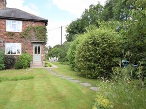 a brick house with a grass yard and a white door at 3 bed property in Harrogate District HH057 in Harrogate