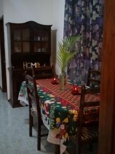 a dining room table with a holiday tablecloth on it at Pritanier in Flic-en-Flac