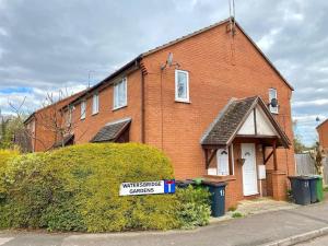 a brick house with a sign in front of it at Nuneaton-GE Hospital 3 mins away in Nuneaton