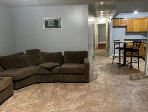 a living room with a couch and a table at Room in a Beach House with King Size bed in a landlord hosted three bedroom apartment in Edgemere
