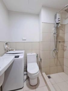 a bathroom with a toilet and a sink and a shower at Azul Condo 2 bedroom Manila in Manila