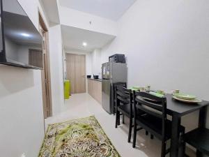 a kitchen with a table and chairs and a refrigerator at Azul Condo 2 bedroom Manila in Manila