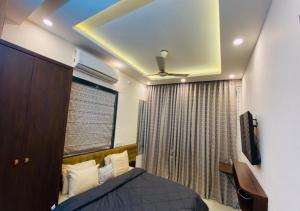 a bedroom with a bed and a ceiling fan at One Infinity Residency in kolkata