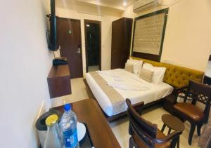 a hotel room with a bed and a table and a table sidx sidx at One Infinity Residency in kolkata