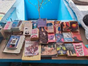 a pile of books sitting on top of a table at Karma homestay in Jodhpur