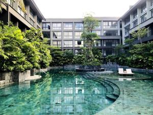 a swimming pool in the middle of a building at Cozy Minimalist Apartment Lavaya N511 in Nusa Dua