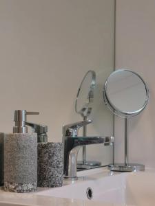 a bathroom sink with a mirror on top of it at Gazeley Gem in Hamilton