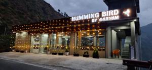 a building with lights and plants in front of it at Humming Bird By Aaryam in Ukhimath