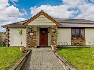 a house with a brick walkway in front of it at 3 Bed in Westward Ho 89869 in Westward Ho